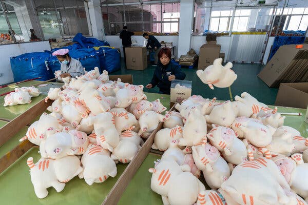 Stuffed toys piled on a production floor.
